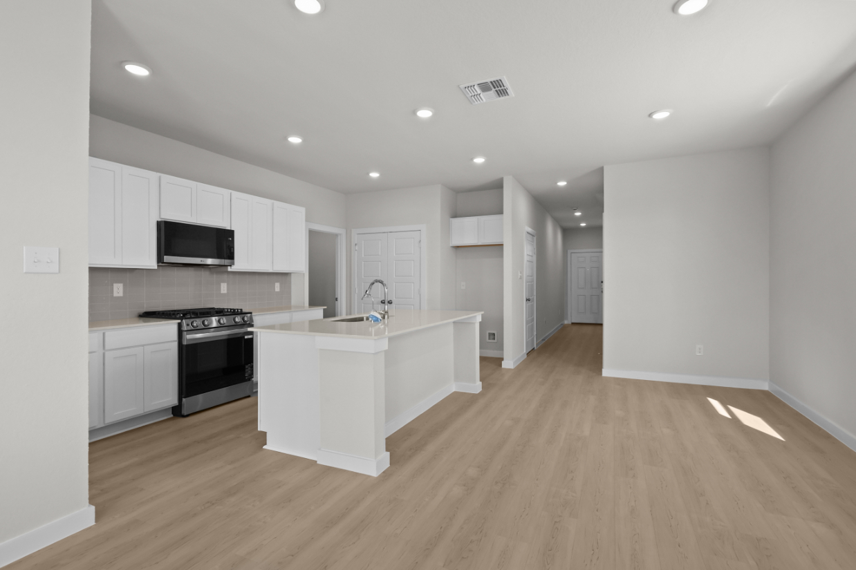 A kitchen with white cabinets.