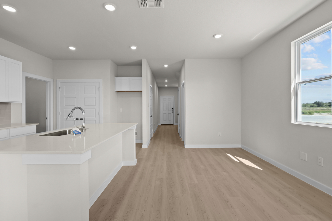 A kitchen with white cabinets.