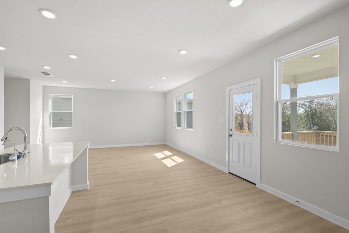 A large bathroom with a wood floor.