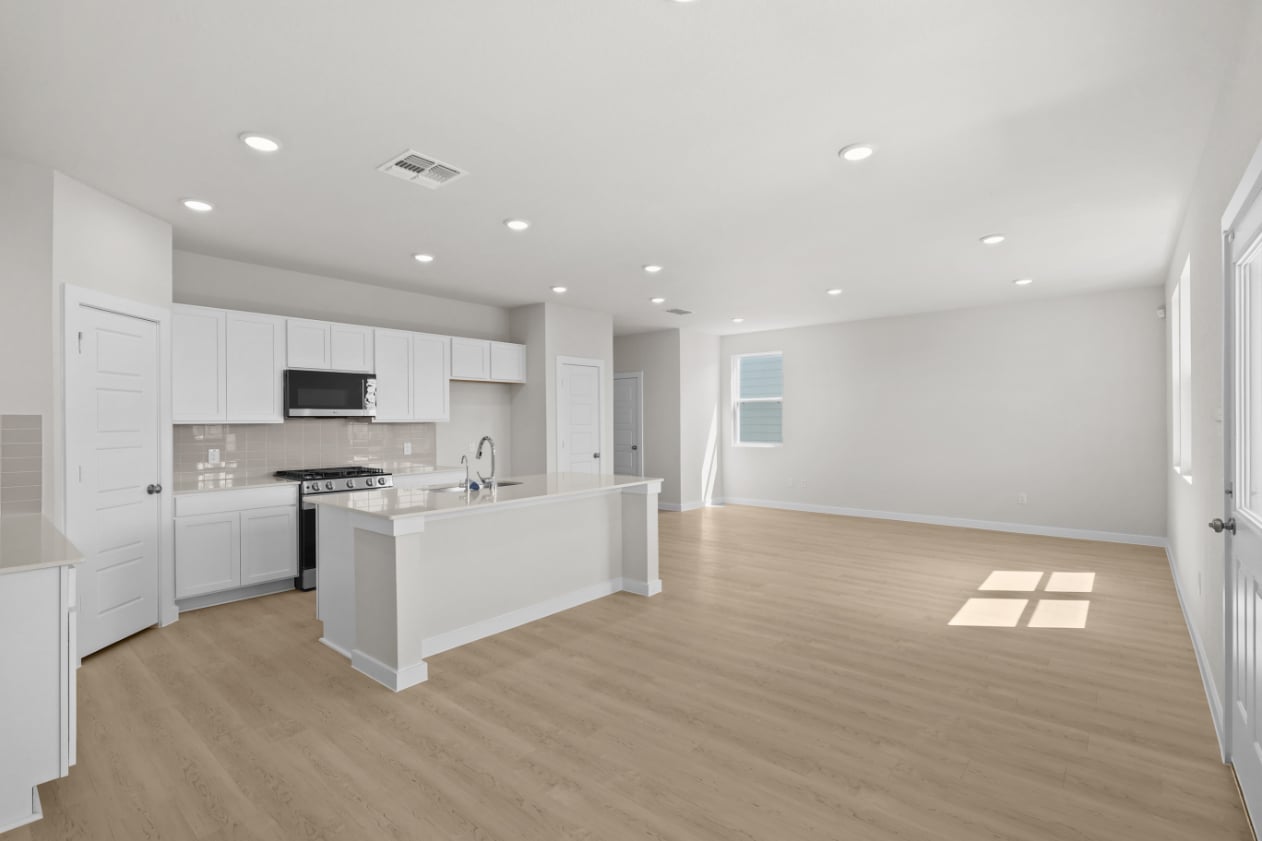 A large kitchen with white cabinets.