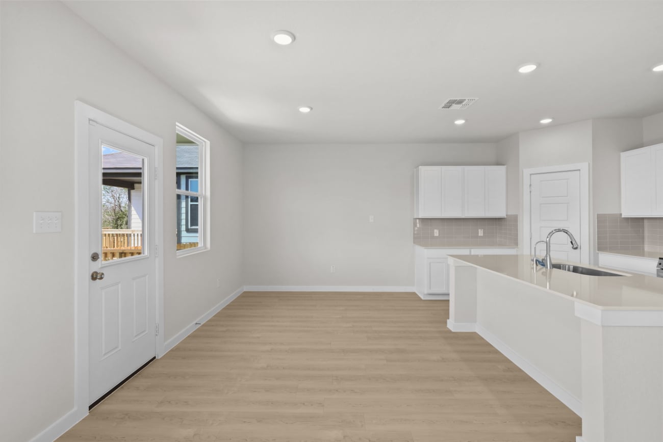 A kitchen with white cabinets.