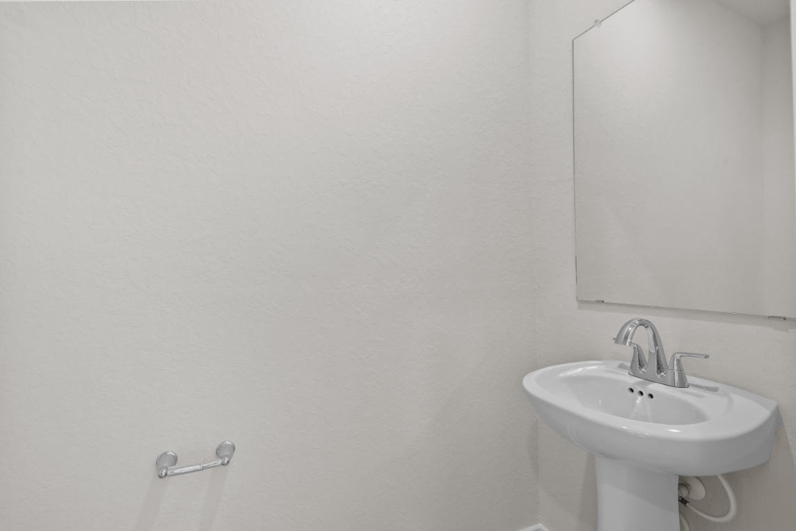 A bathroom with a mirror and sink.