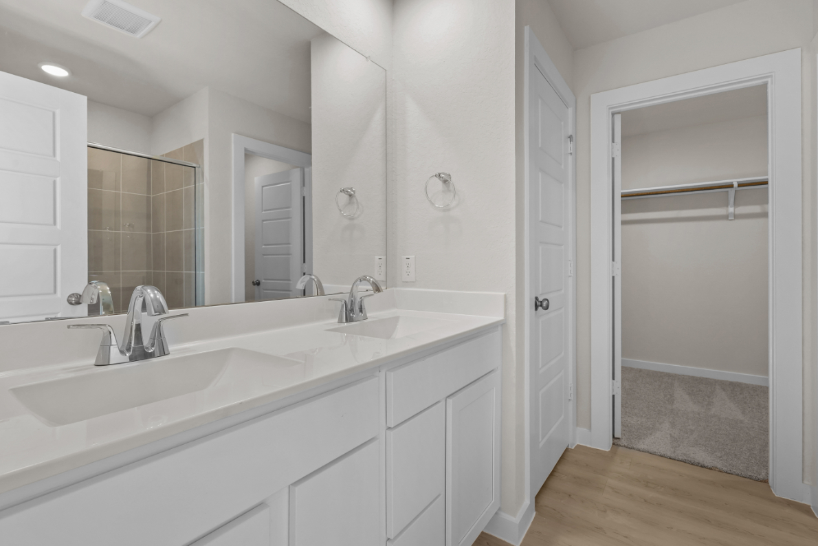 A bathroom with a tub sink and a shower.