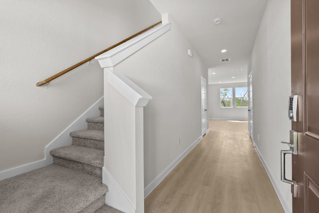 A hallway with white walls.