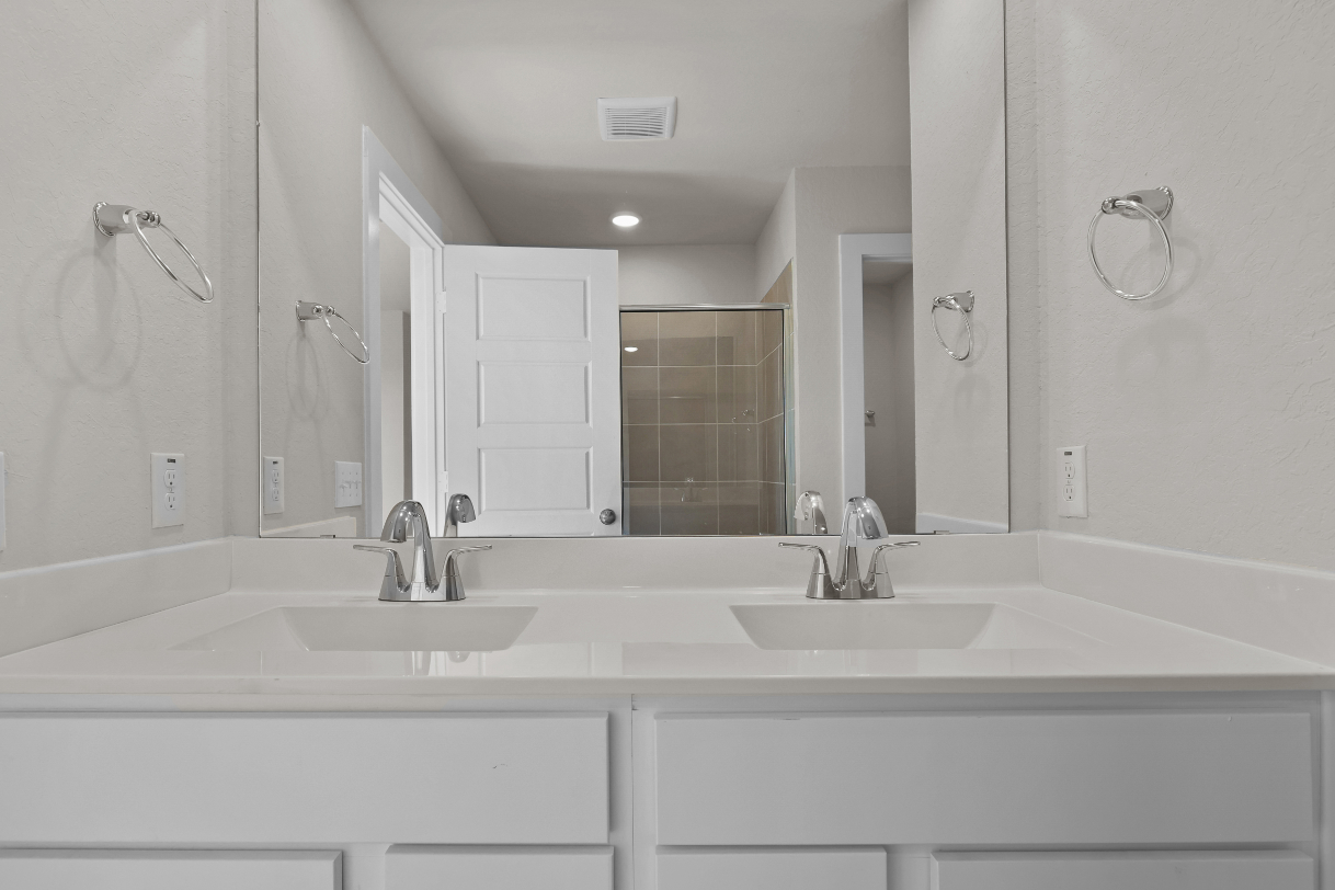 A bathroom with a large mirror.