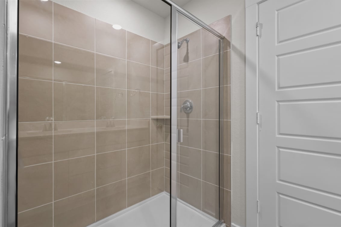 A shower with a glass door.