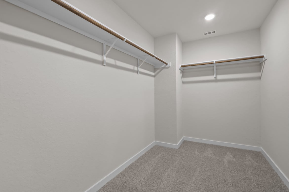 A white hallway with a metal railing.