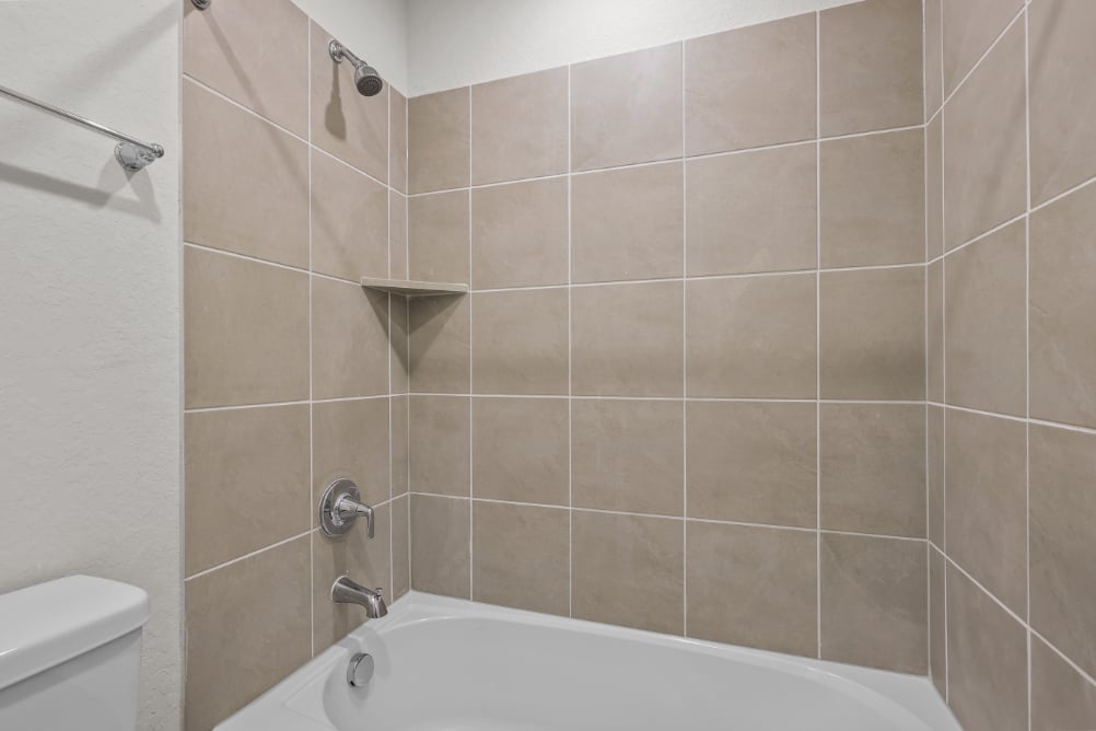 A bathtub in a bathroom.