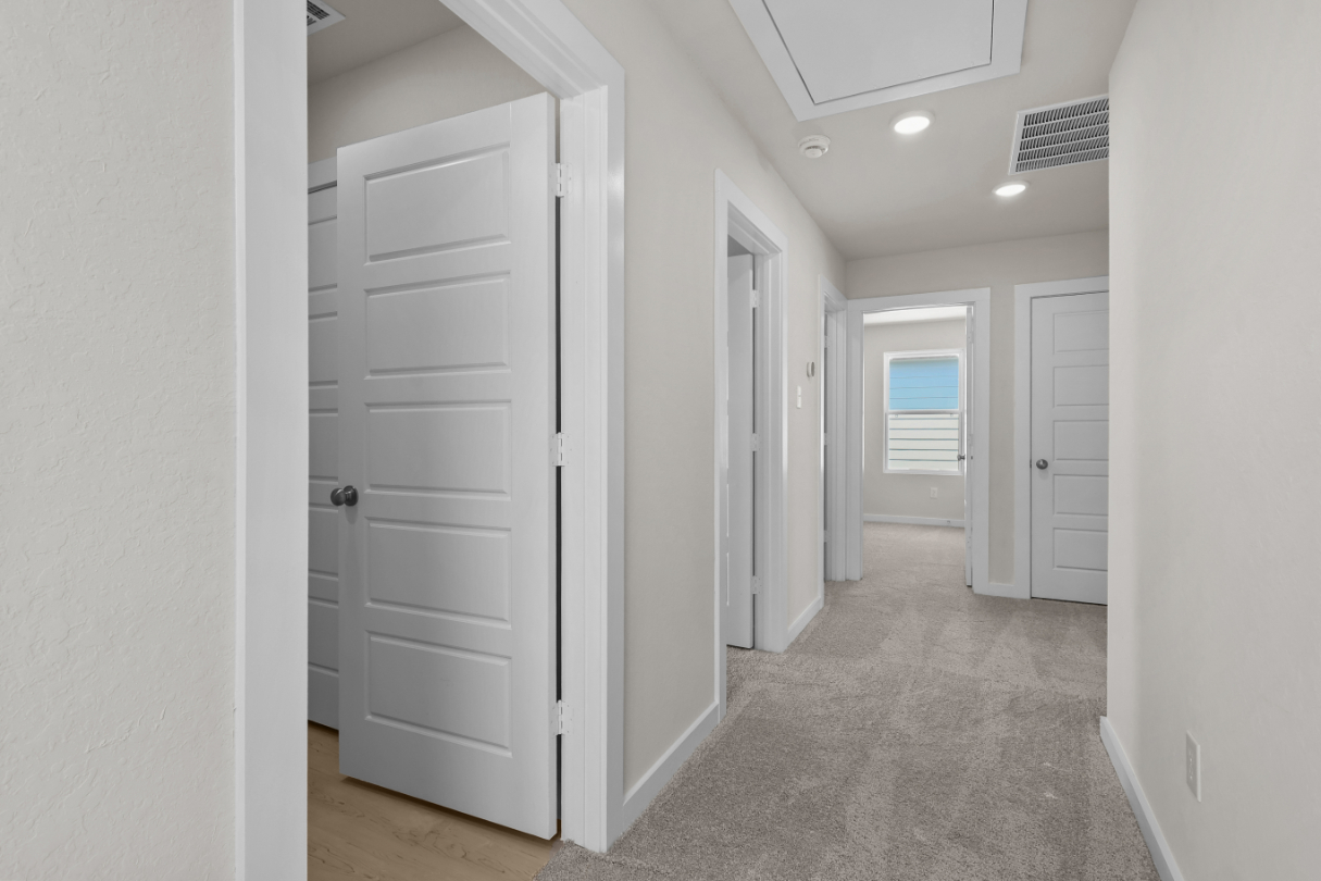 A hallway with white doors.