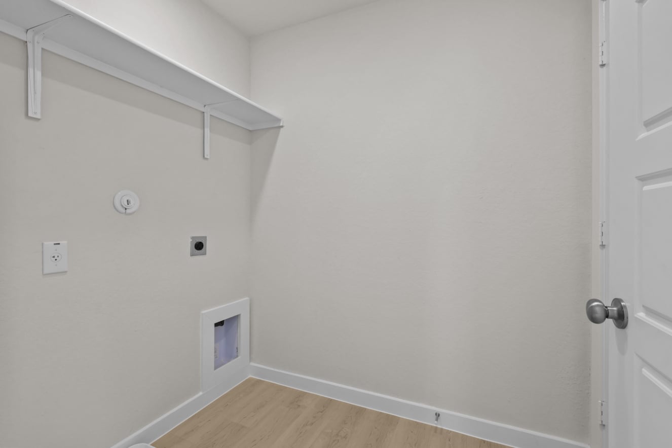 A white wall with a door and a white door.