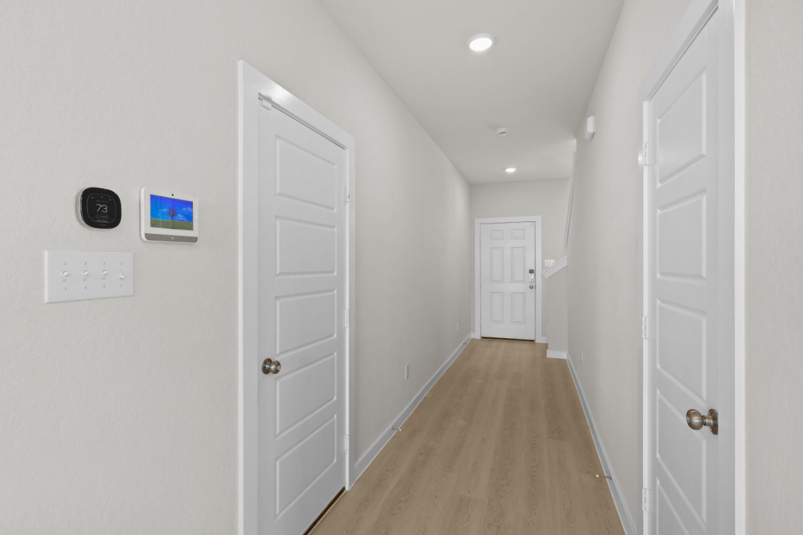 A hallway with white doors.