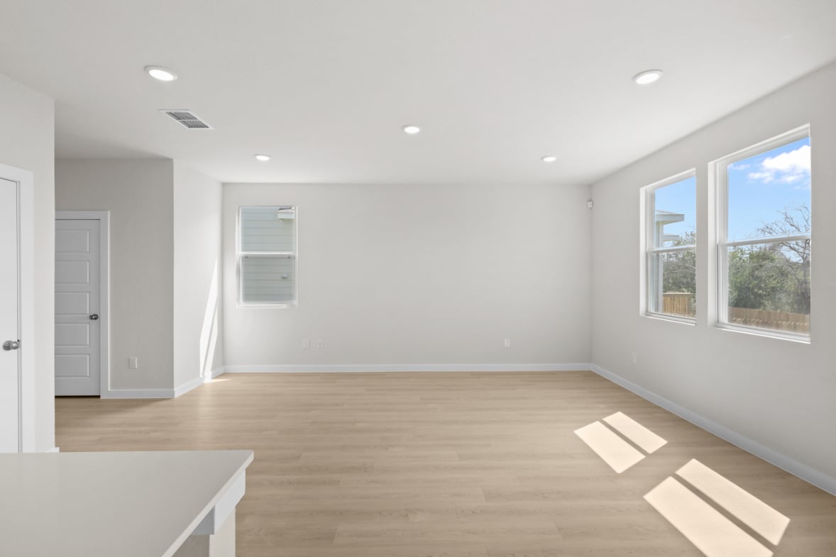 A room with a wood floor and windows.
