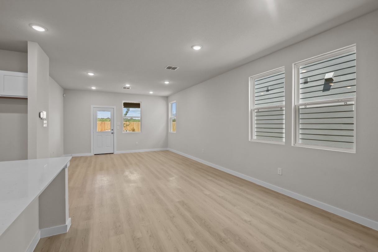 A room with white walls and a wood floor.