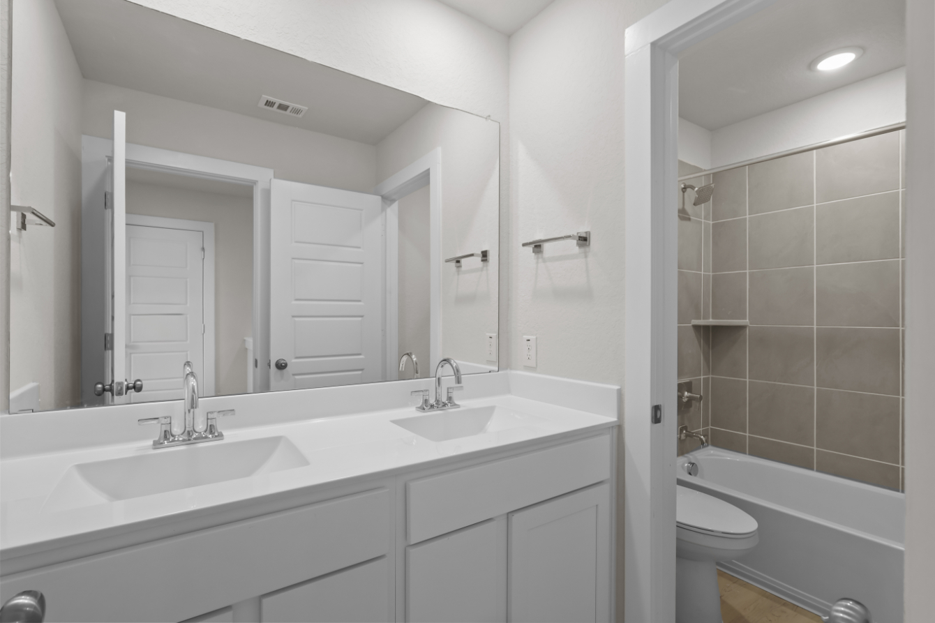 A bathroom with a sink and a toilet.