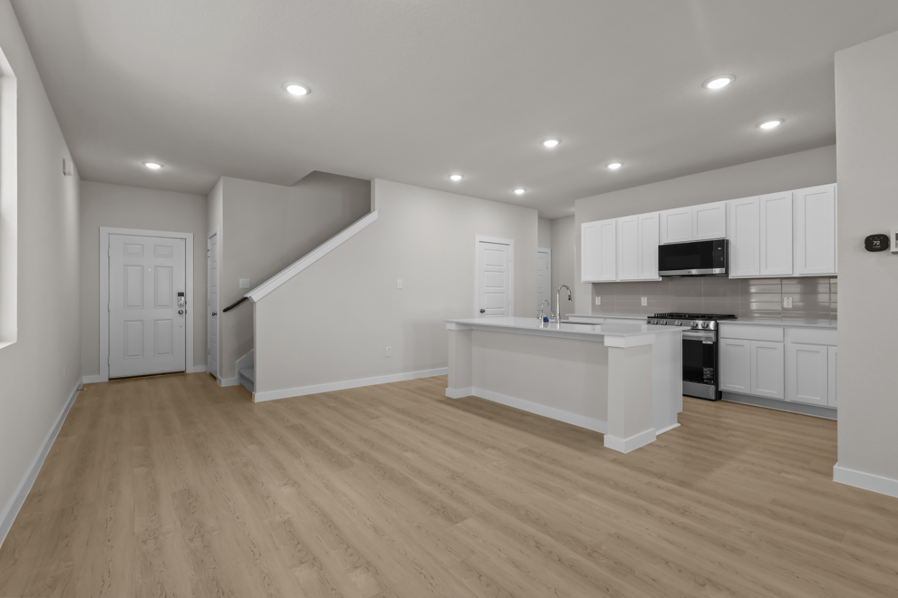A kitchen with white cabinets.