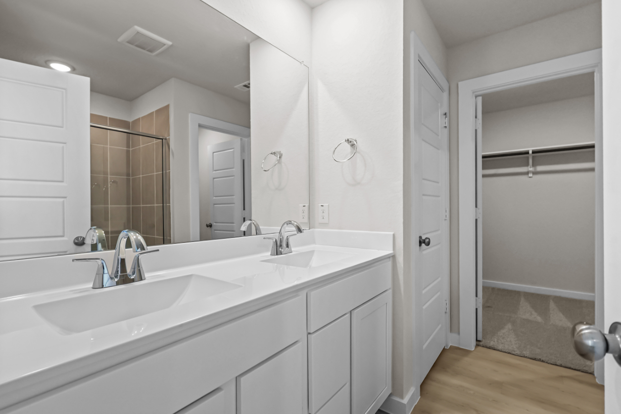A bathroom with a tub sink and shower.