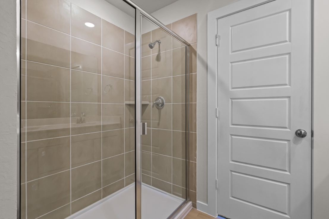 A shower with a glass door.