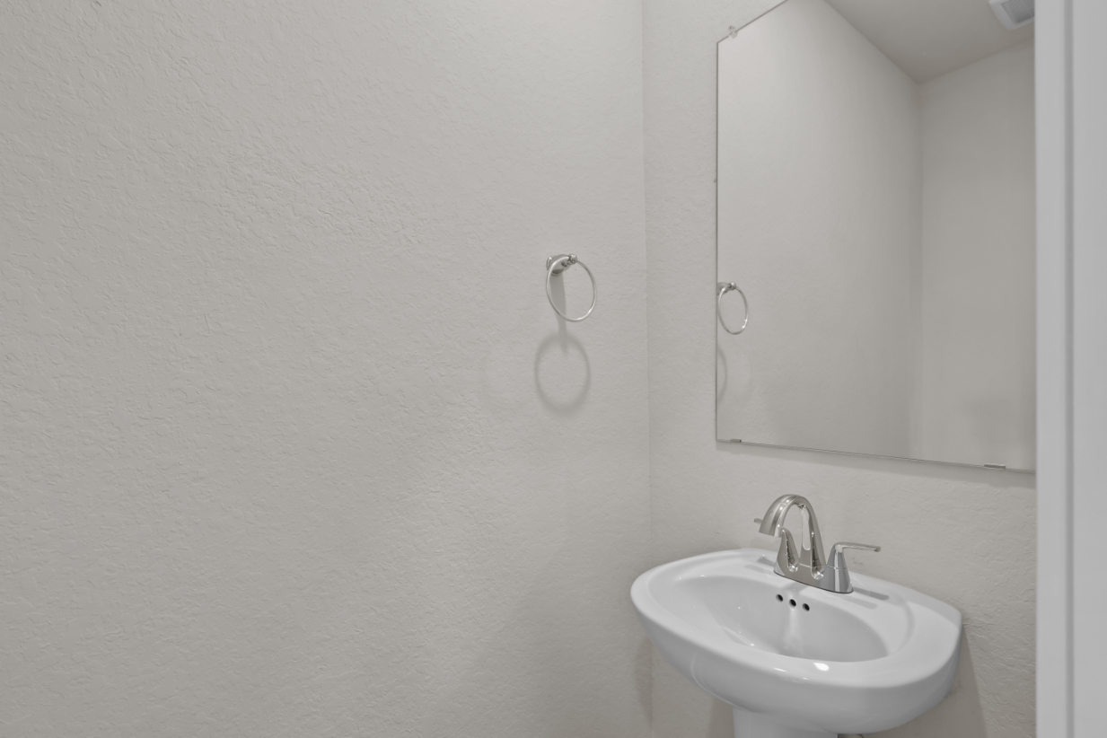 A bathroom with a mirror and sink.