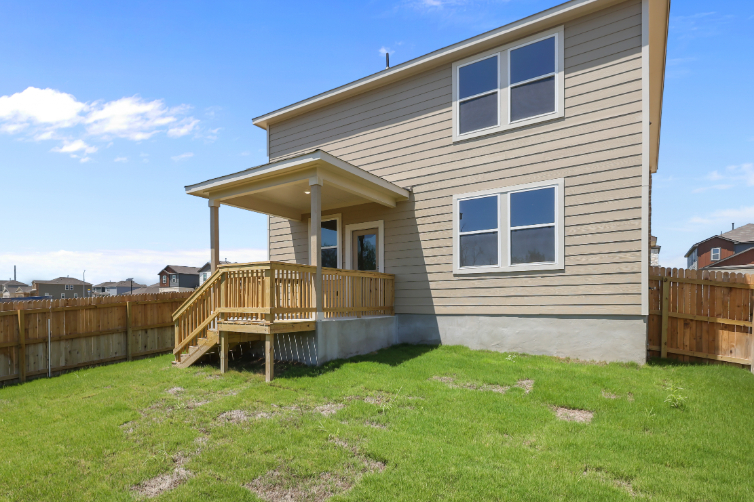 A house with a fence and grass.