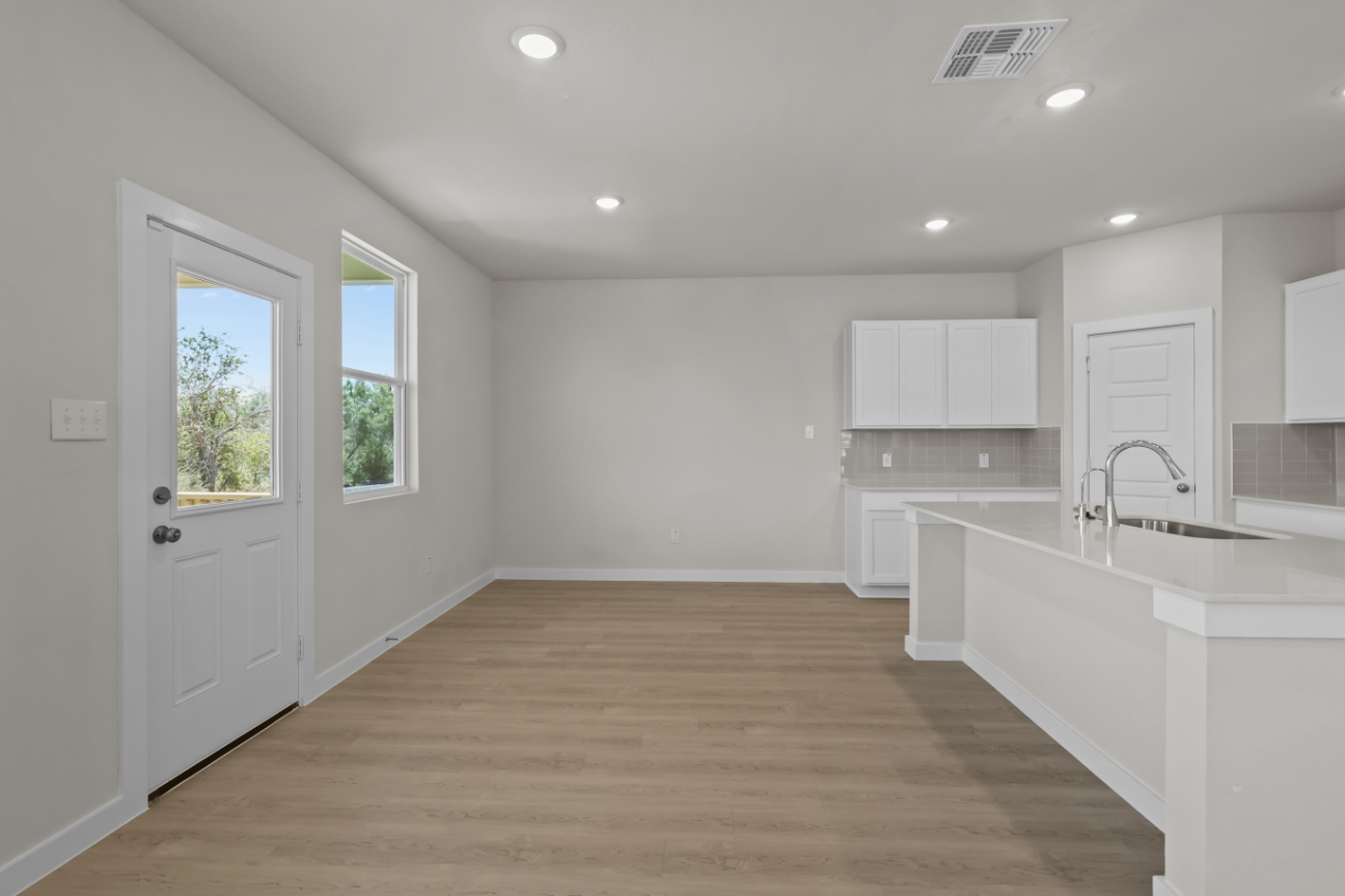 A kitchen with white cabinets.