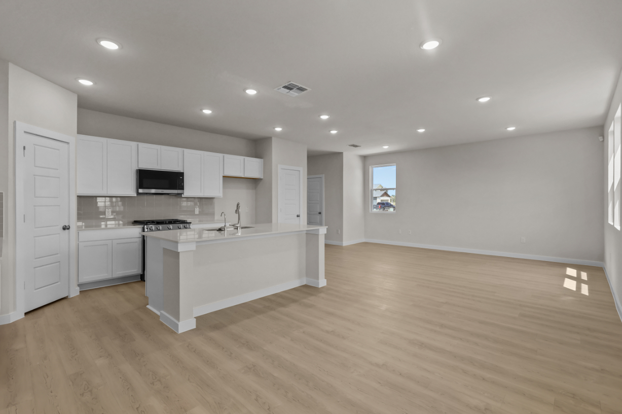 A large kitchen with white cabinets.
