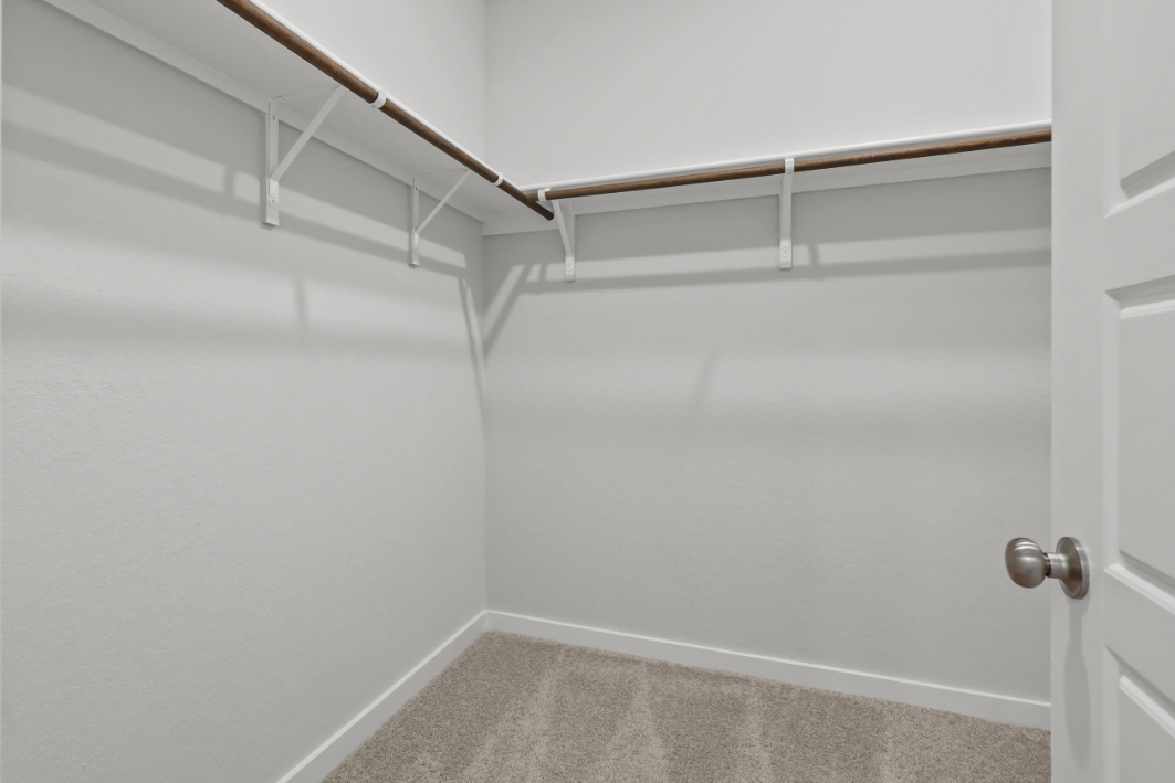 A white staircase with a white door.