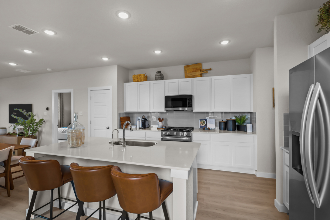 A kitchen with white cabinets.