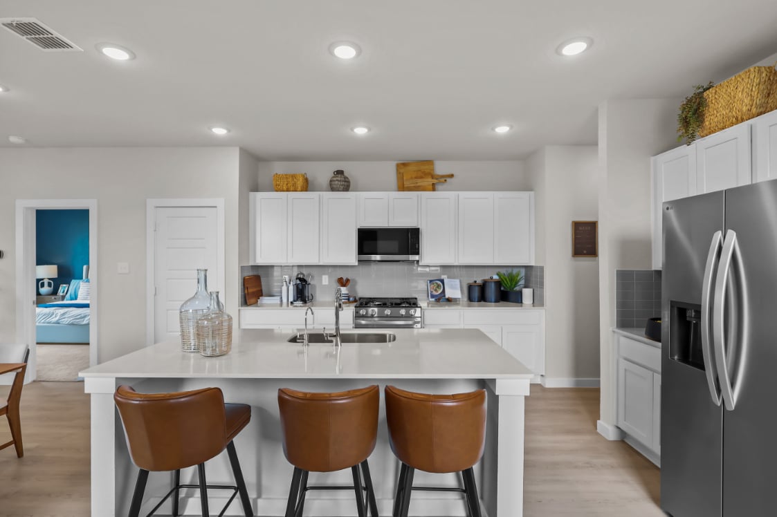 A kitchen with white cabinets.