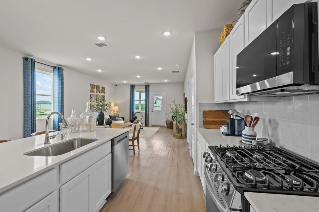 A kitchen with a stove and a sink.
