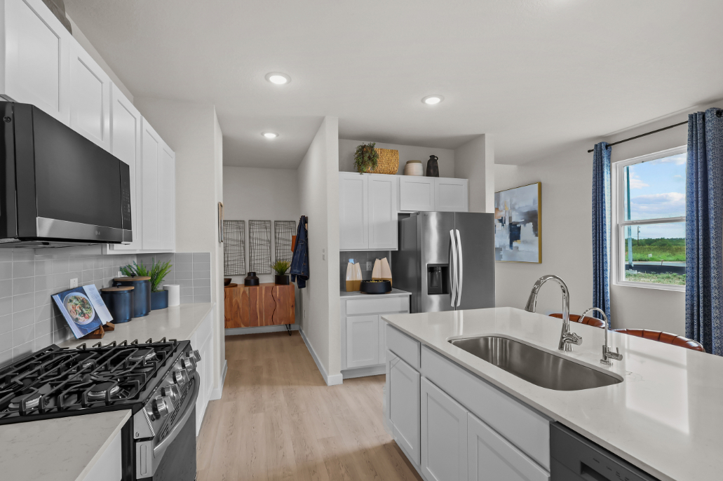 A kitchen with white cabinets.