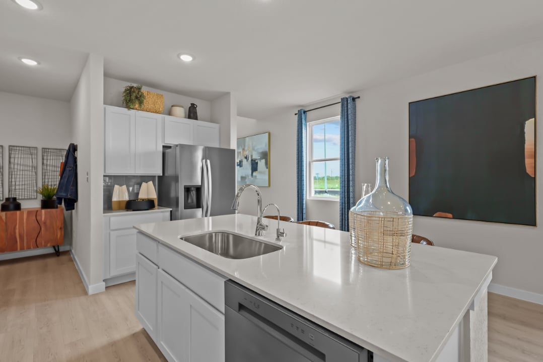 A kitchen with white cabinets.