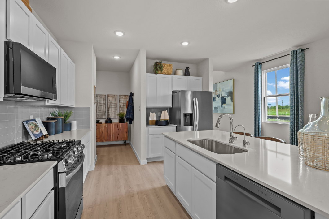 A kitchen with white cabinets.