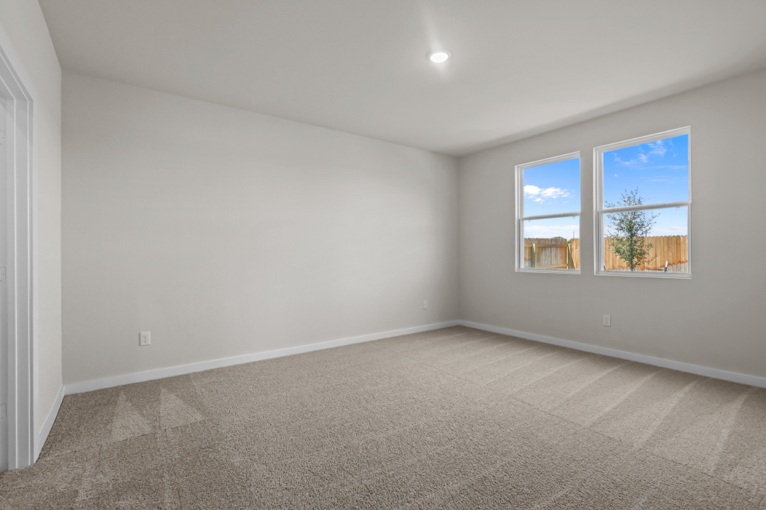 A room with a window and a carpet.
