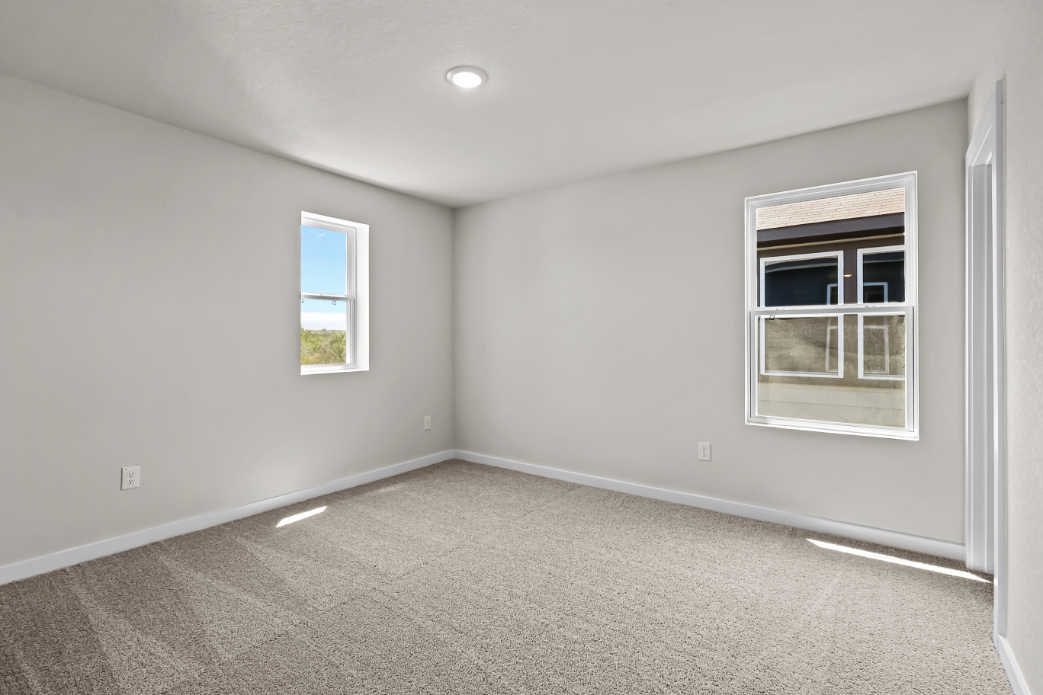 A room with windows and carpet.