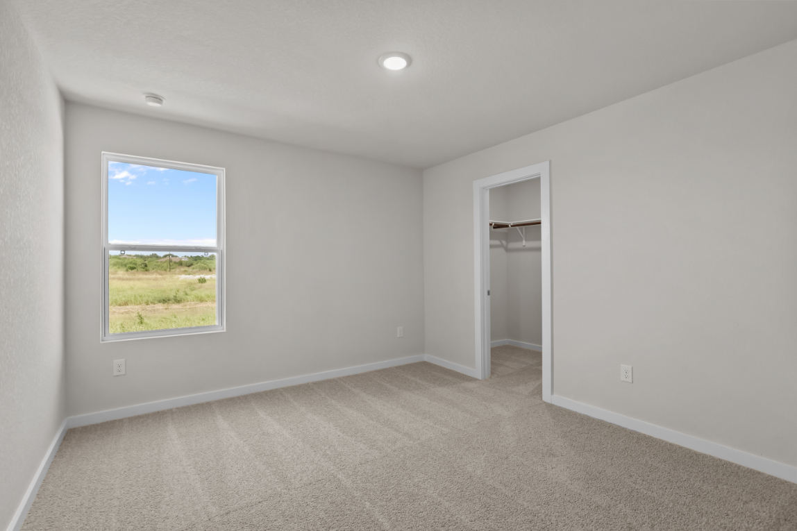 A room with a window and a door.
