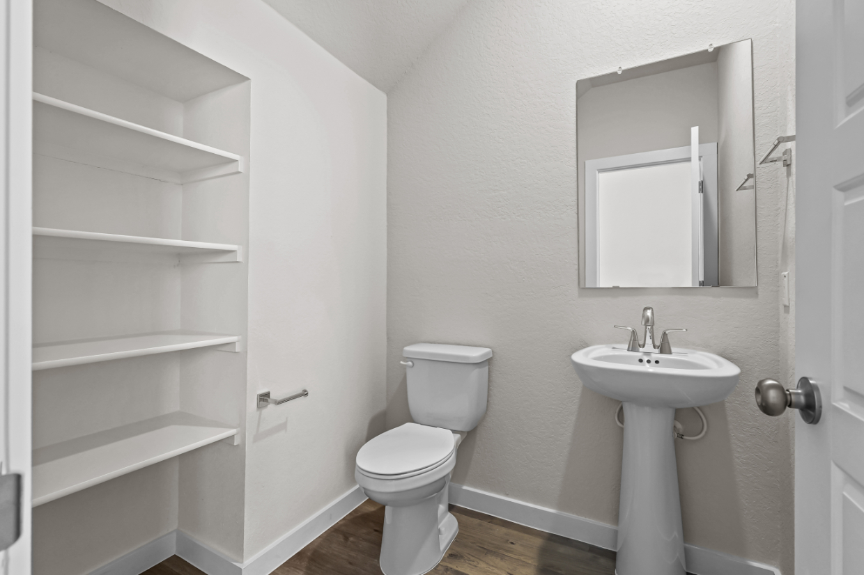 A bathroom with a toilet and sink.
