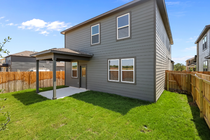 A house with a fence and grass.