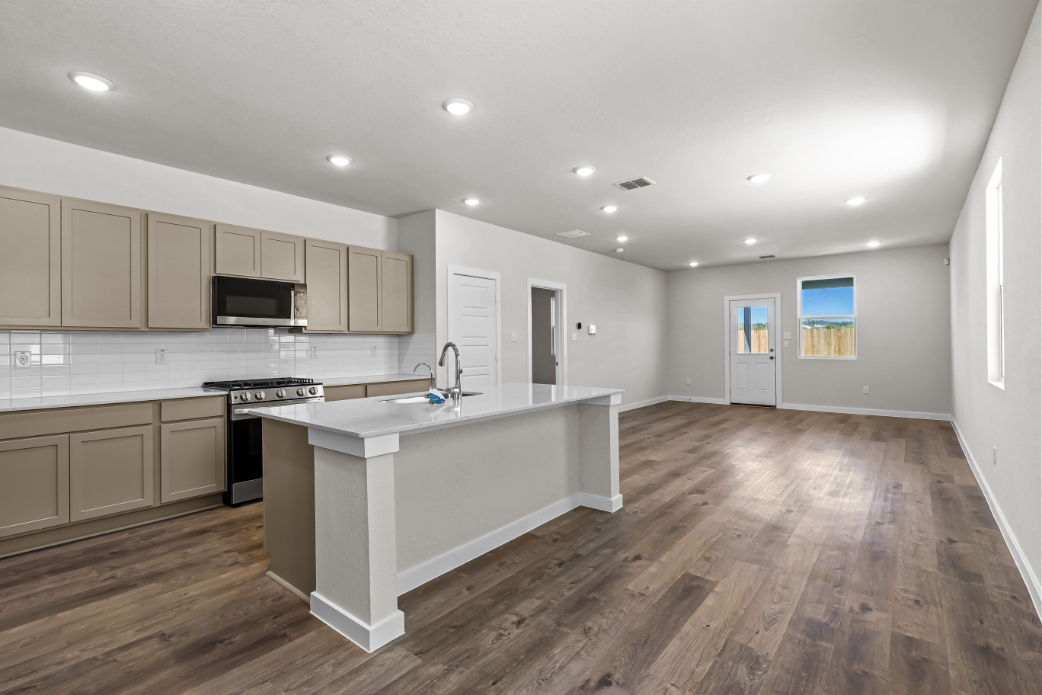 A kitchen with white cabinets.