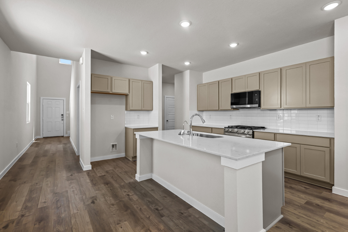 A kitchen with white cabinets.