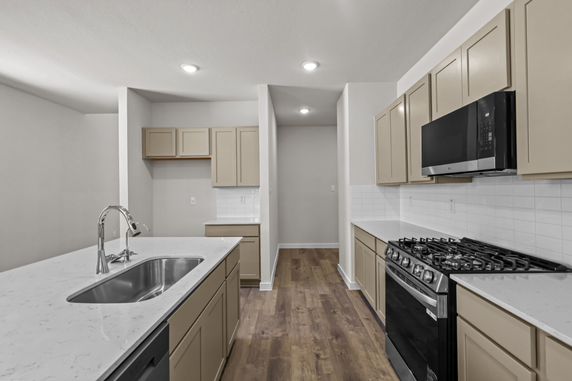 A kitchen with white cabinets.