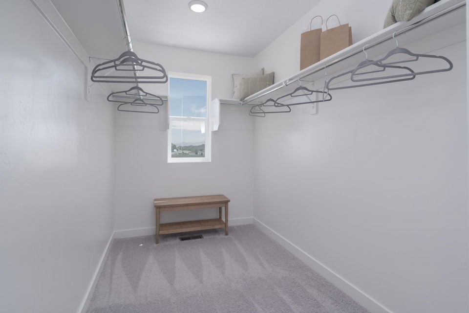 A room with a bench and a shelf with a lamp on it.