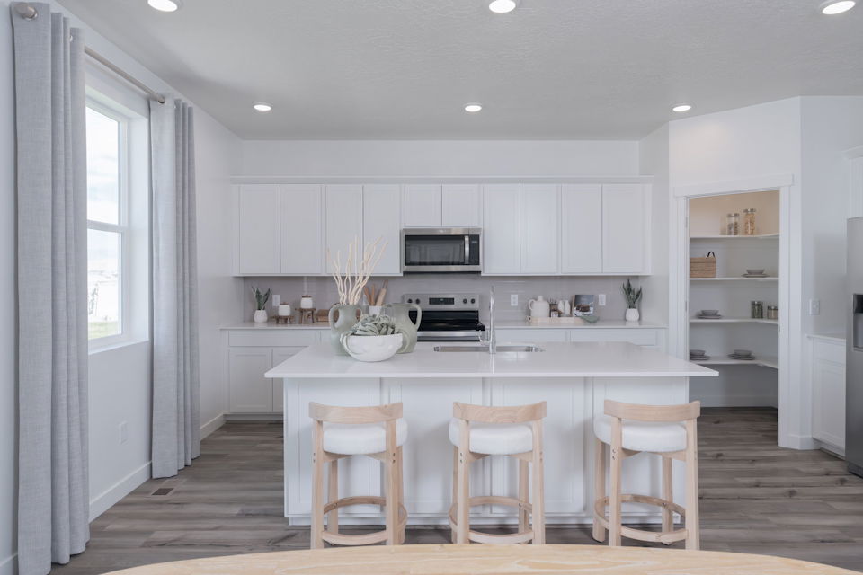 A kitchen with white cabinets.