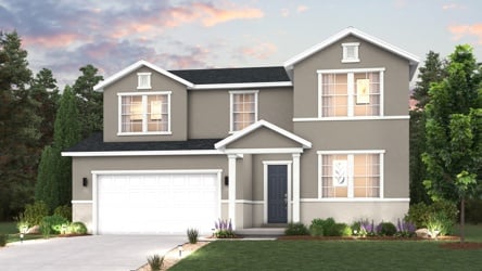 A house with a garage and trees around it.