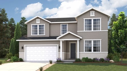 A house with a garage and trees.