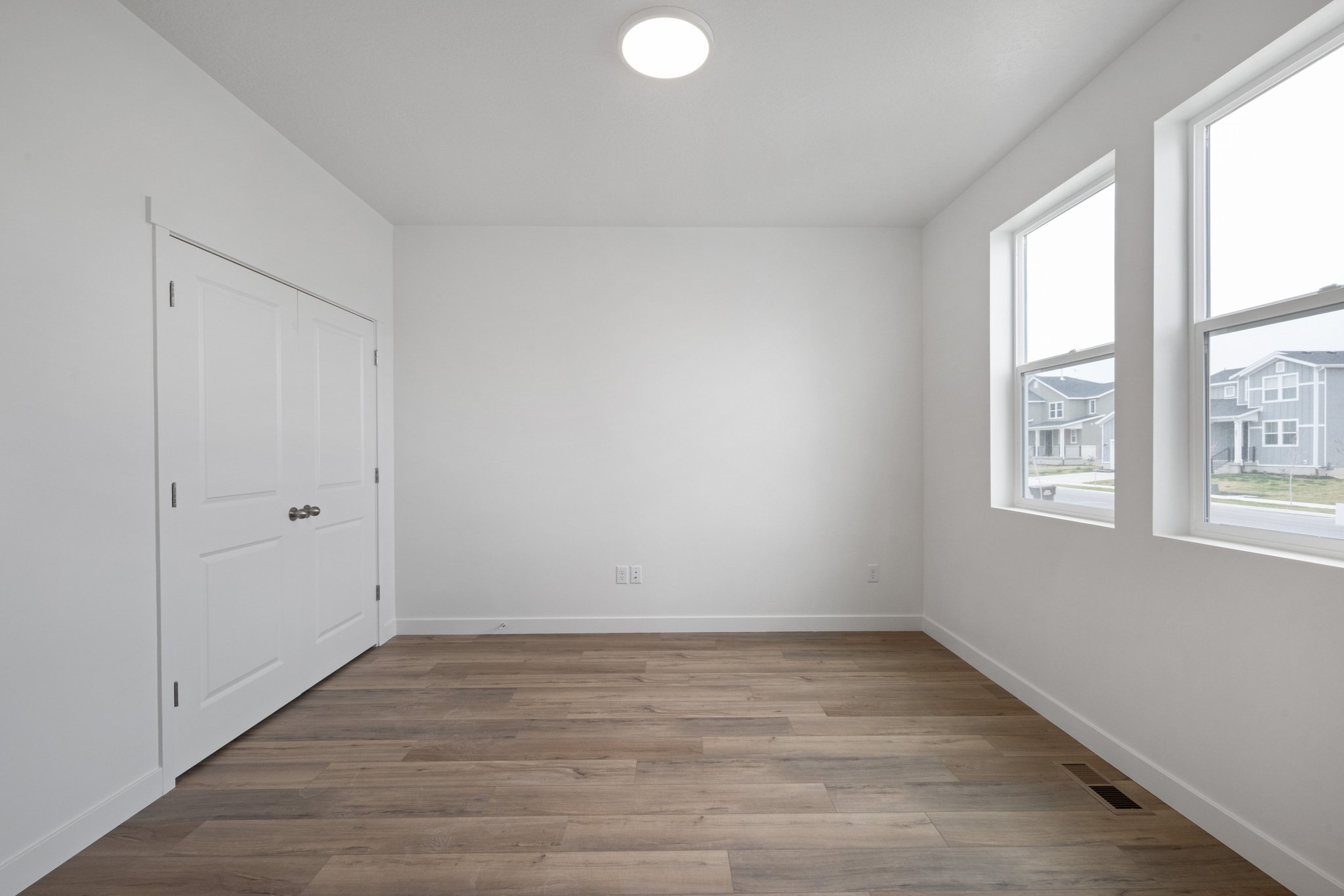 A room with white walls and windows.