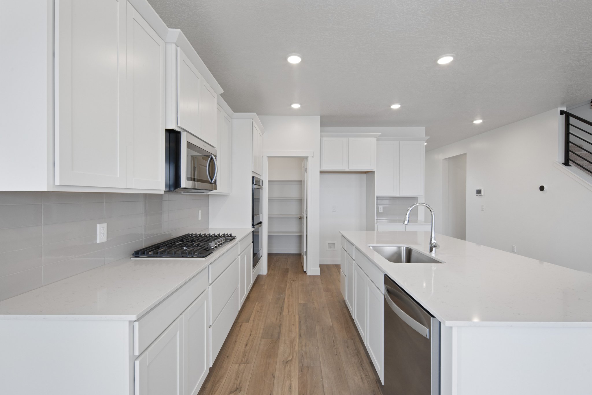 A kitchen with white cabinets.