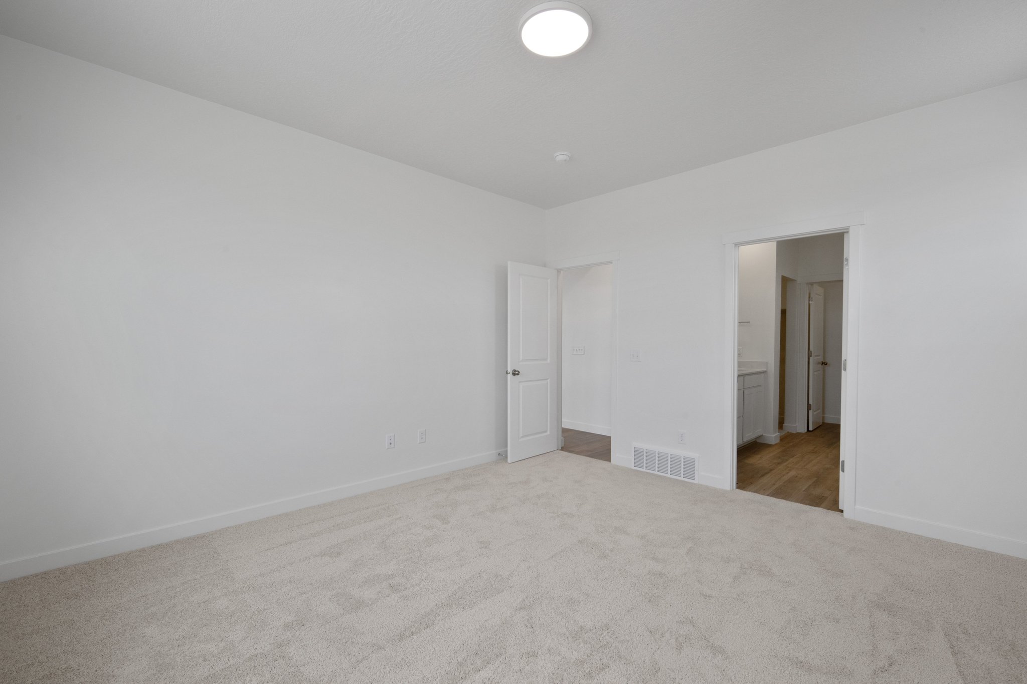 A hallway with white walls.