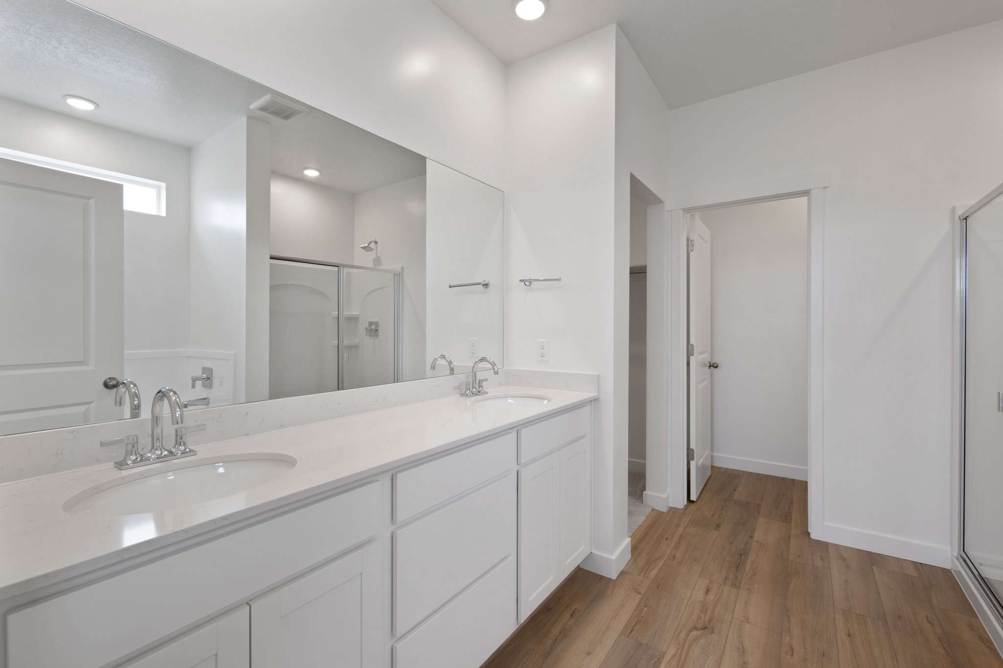 A bathroom with white cabinets.
