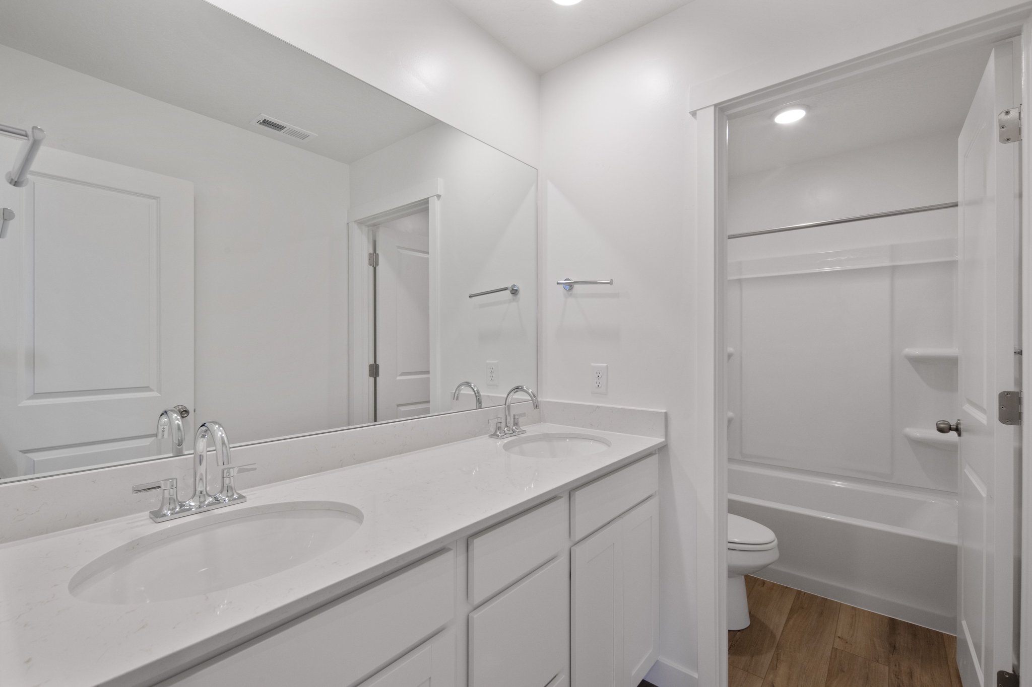A bathroom with a tub sink and toilet.