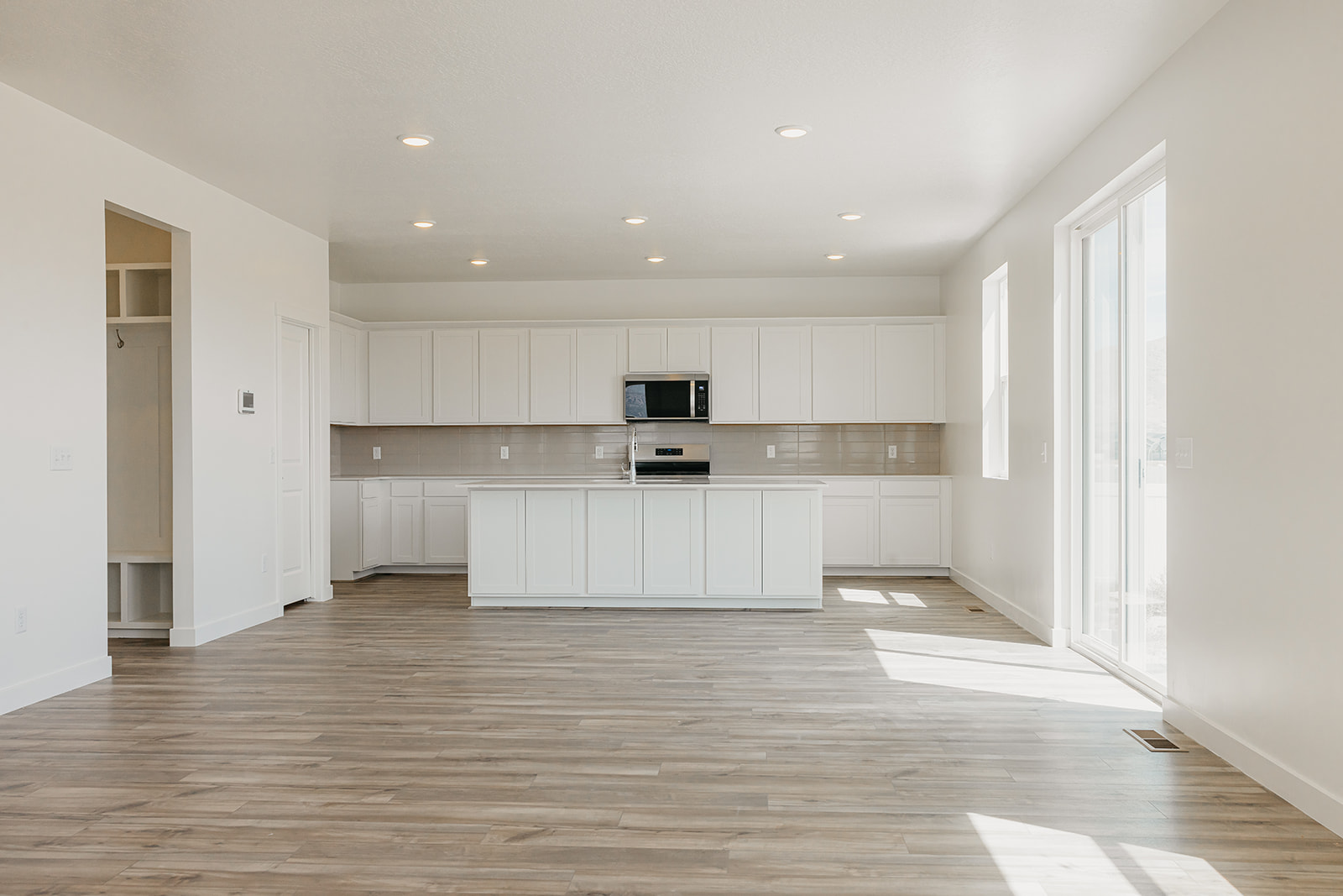 A large kitchen with white cabinets.
